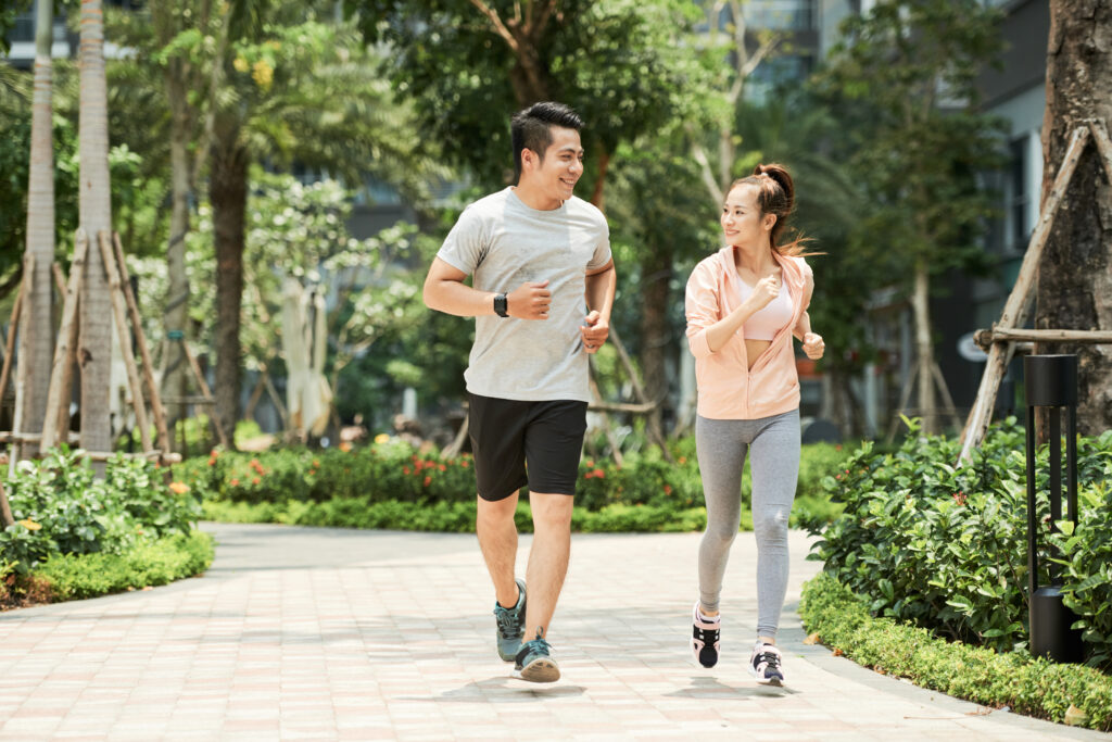 Married couple jogging outdoors together, symbolizing shared growth and mutual support in a healthy relationship