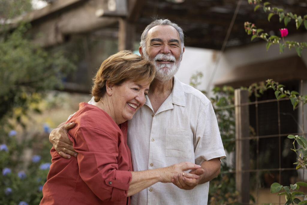 Elderly couple holding hands on a porch swing, representing decades of dedication and lasting love