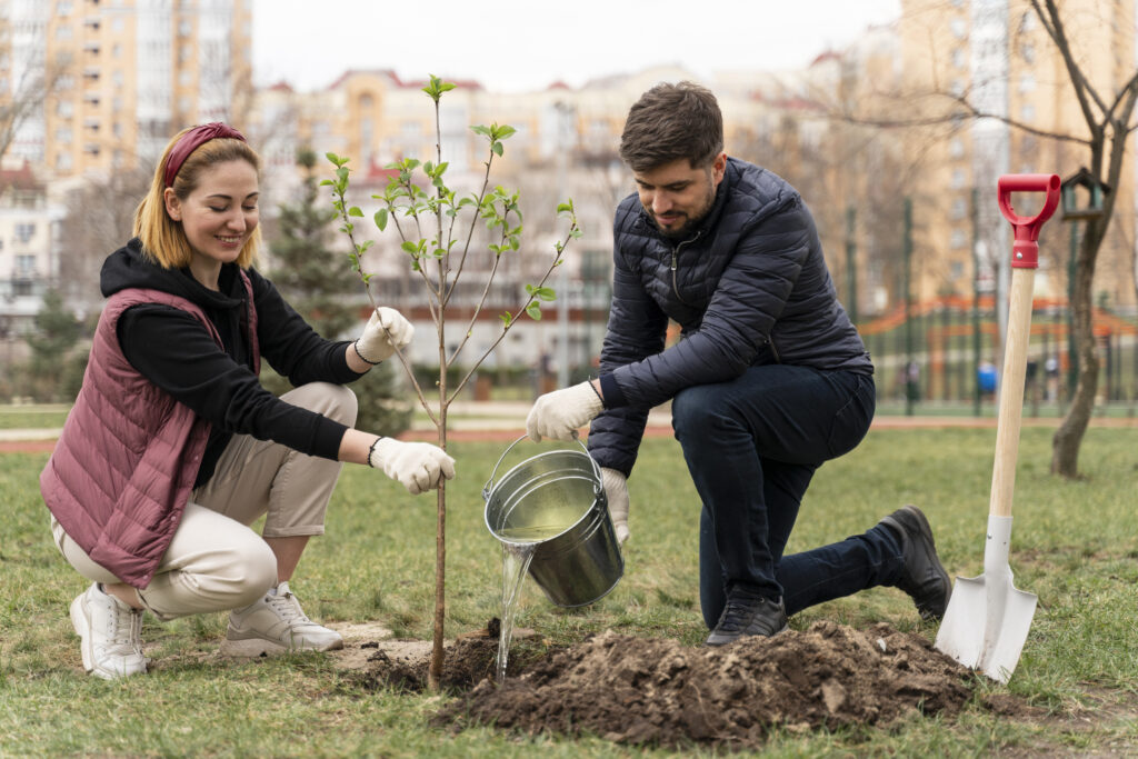 Husband and wife planting a tree in their yard, symbolizing long-term investment and shared purpose in marriage