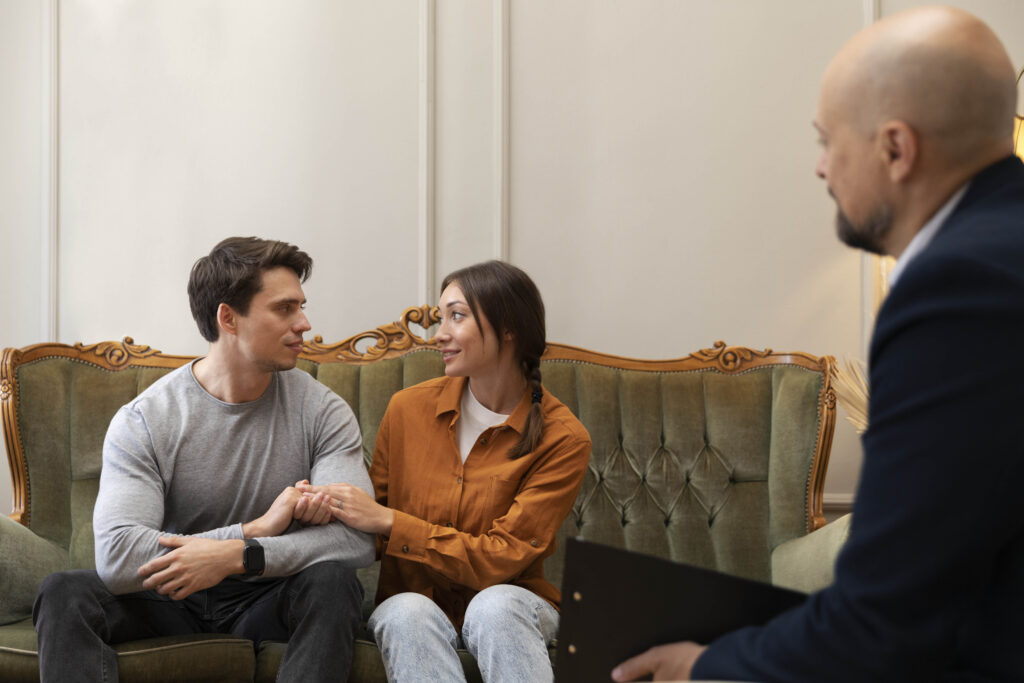 Couple holding hands during a therapy session, symbolizing the decision to rebuild love with outside suppor