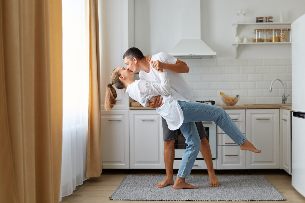 Married couple dancing in the kitchen, showing joy rediscovered in everyday moments after choosing to stay