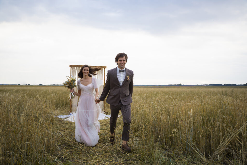  A bride and groom walking off into the distance after a wedding ceremony