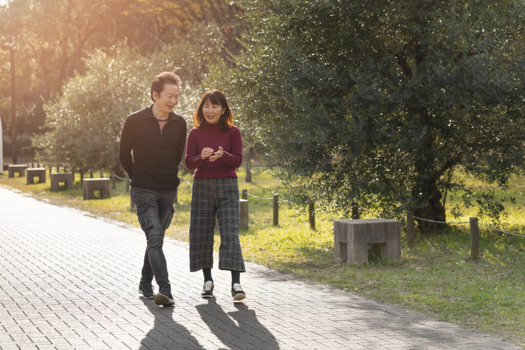 Husband and wife spending quality time together on a peaceful park walk