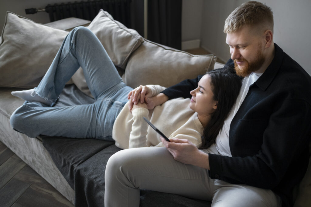 Married couple sitting quietly together, showing emotional presence and silent support
