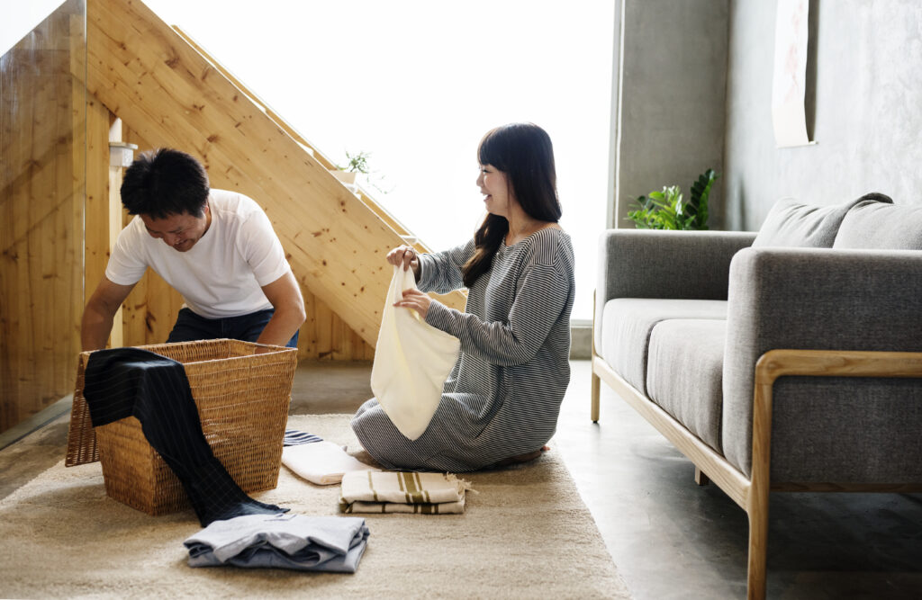 Married couple folding laundry together, illustrating loyalty and teamwork in daily life
