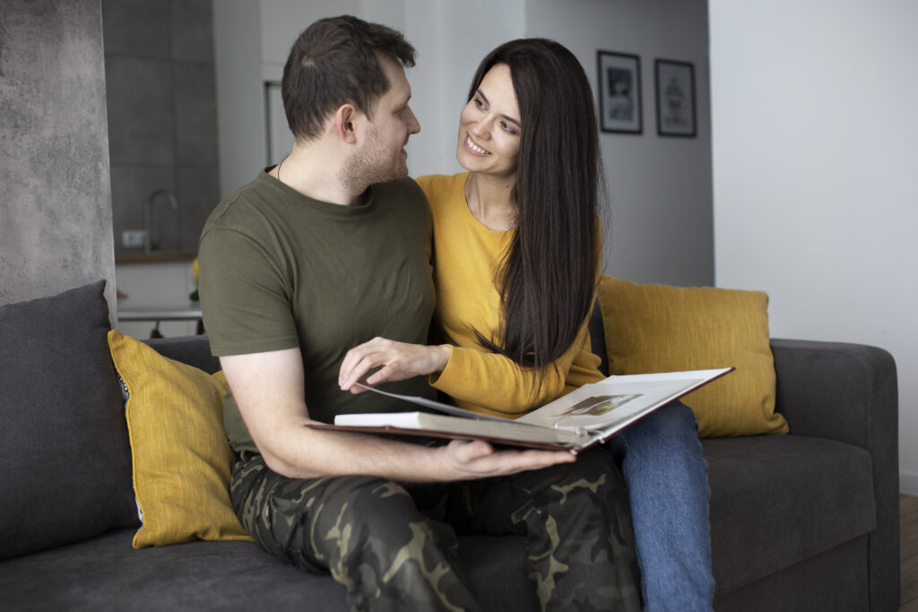 Couple looking at a photo album together in silence