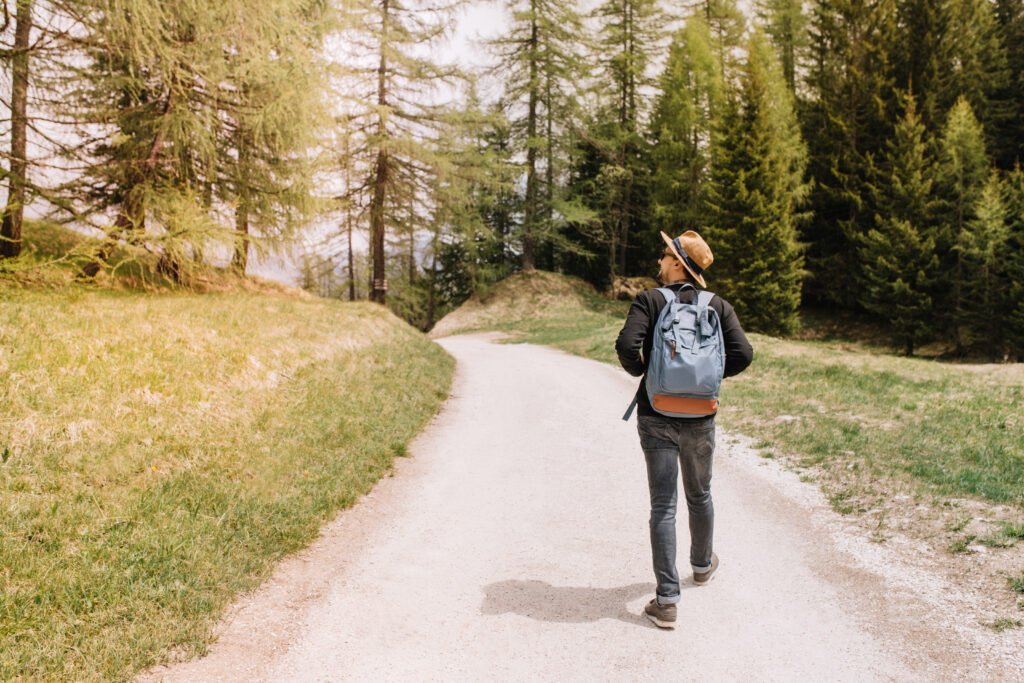 A person walking alone on a forest path, symbolizing inner strength and personal progress even when the road feels lonely.”