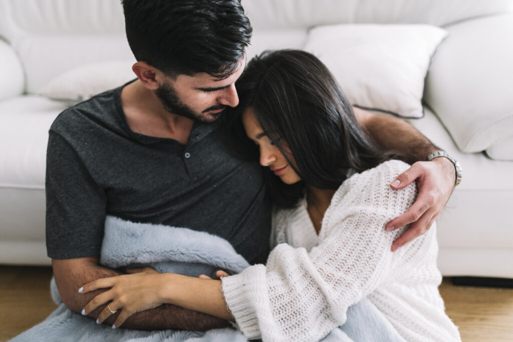 Spouse holding their partner through a moment of emotional difficulty, demonstrating unconditional love