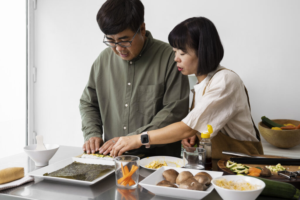 Married couple smiling while working together at home, illustrating appreciation through teamwork