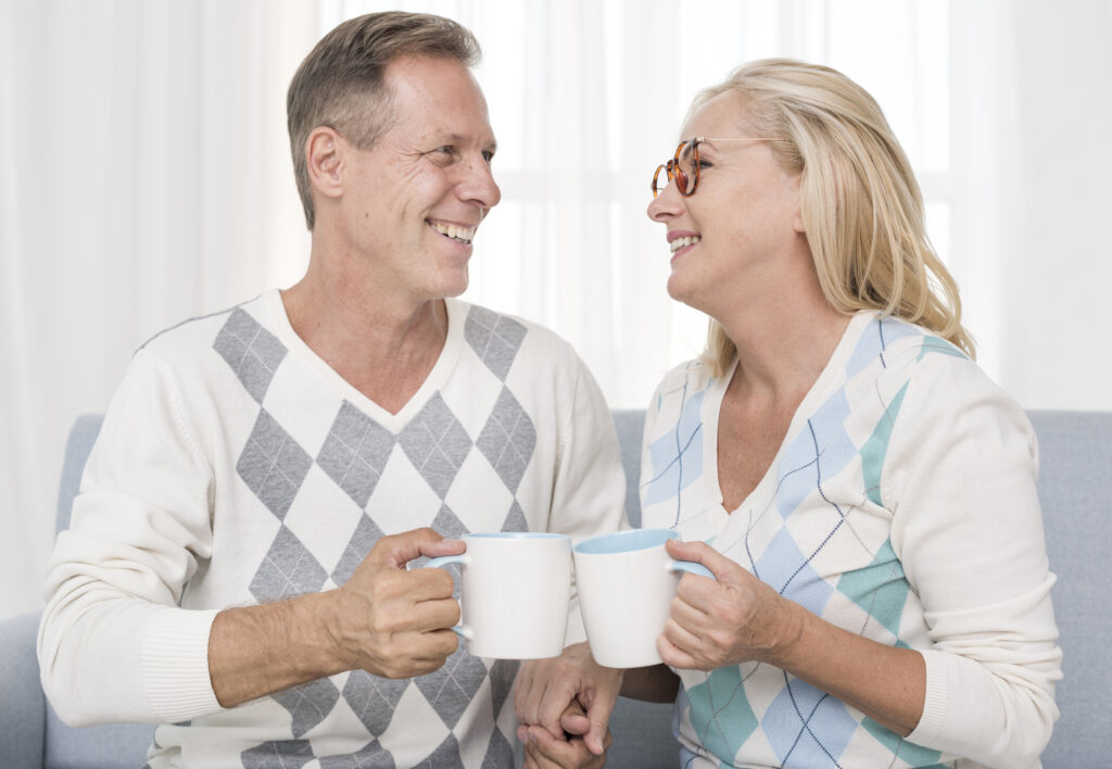 Aging couple enjoying morning coffee together, representing a long-lasting joyful bond
