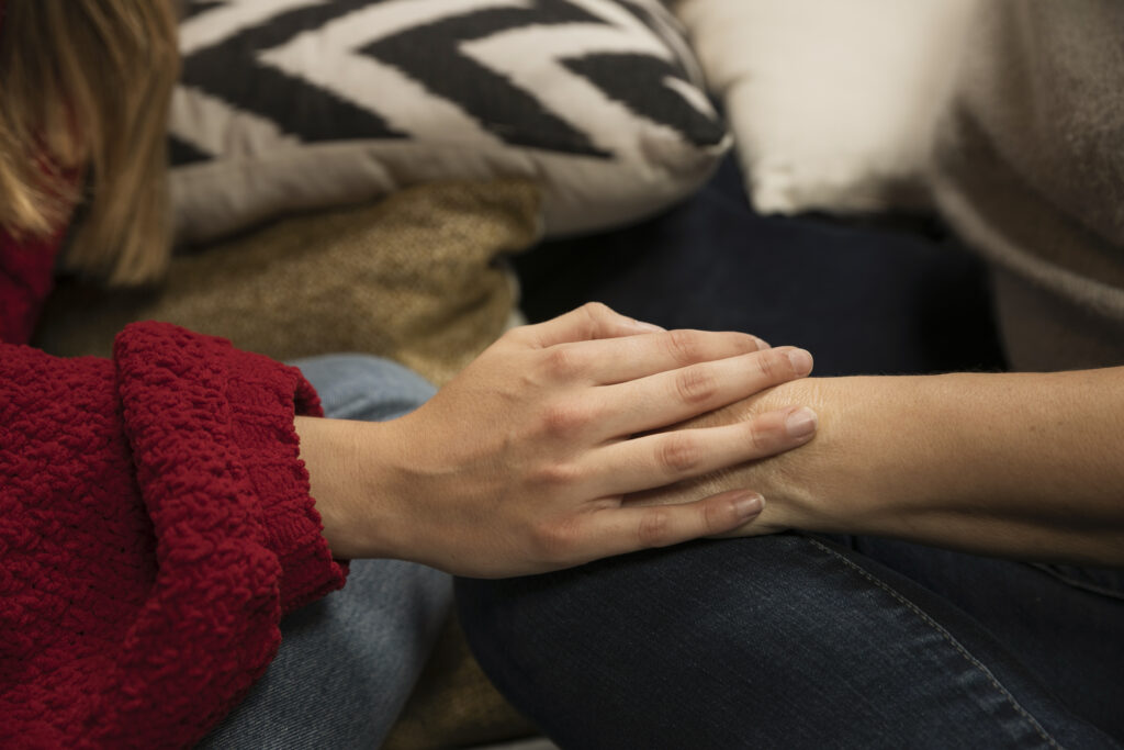Symbolic image of one partner reaching for connection while the other remains emotionally distant.