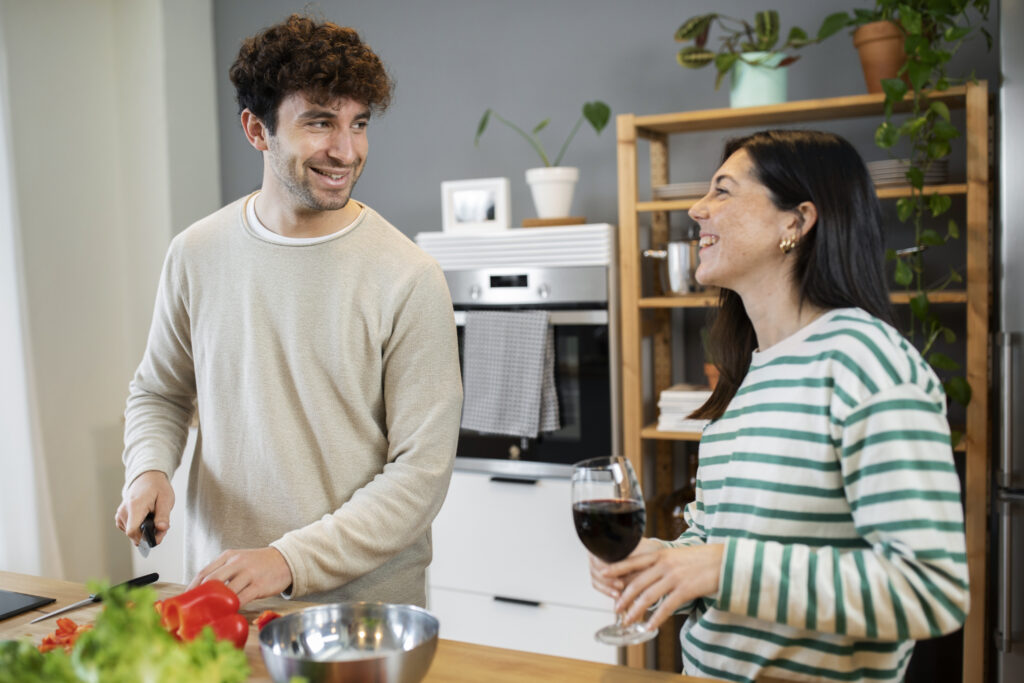 Couple laughing and enjoying each other’s differences while cooking in the kitchen