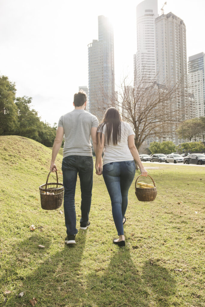 Married couple walking hand-in-hand through a peaceful park, representing steady commitment over time