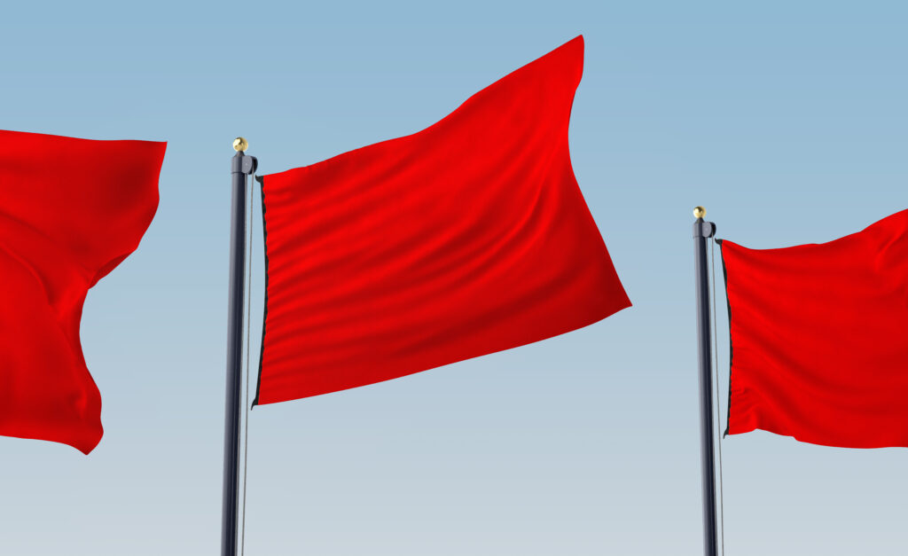 Red flags in the wind, symbolizing early warning signs before marriage