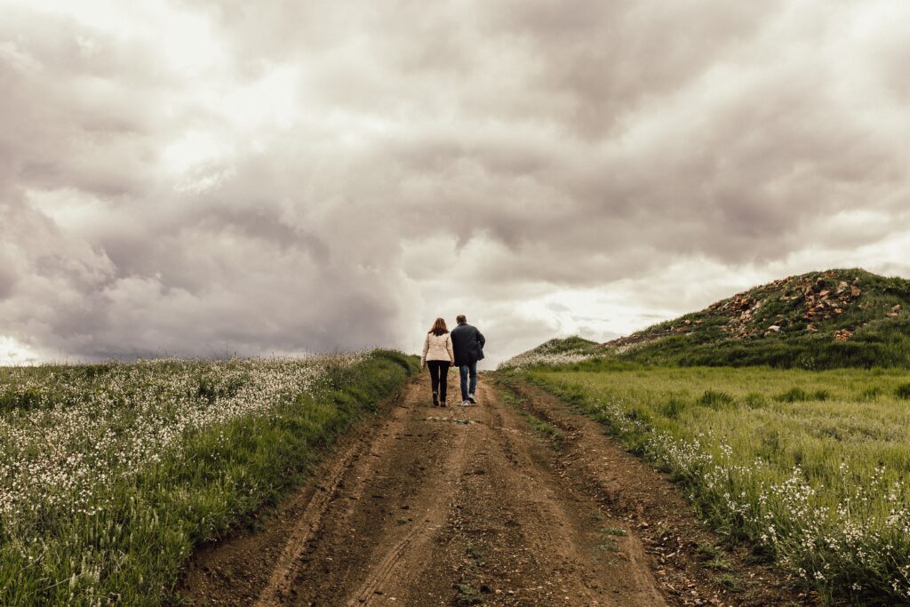 Couple walking hand-in-hand down a winding path, representing the lifelong journey from lust to loyalty in marriage