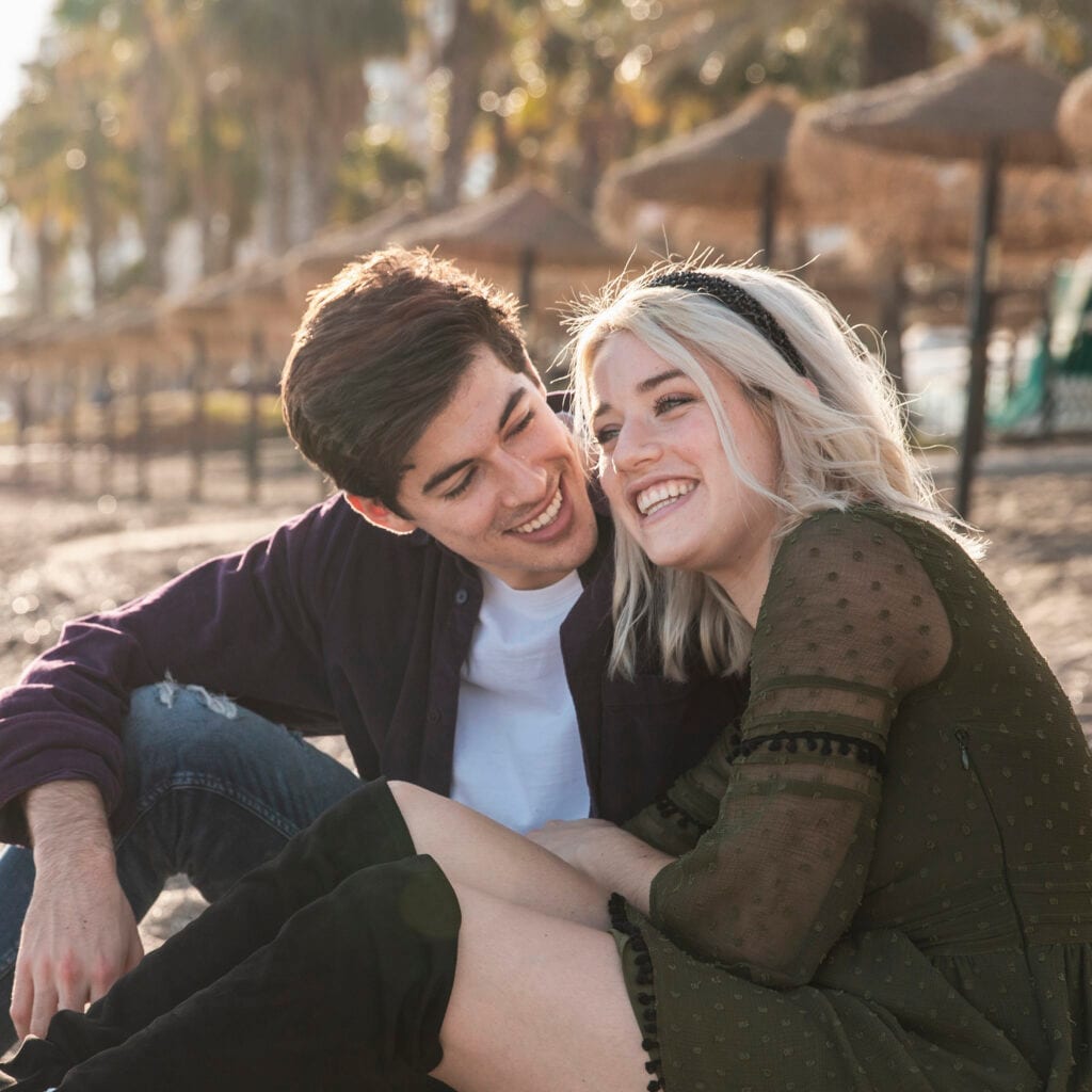 Happy couple genuinely smiling and engaging in heartfelt conversation, symbolizing emotional intimacy and genuine communication