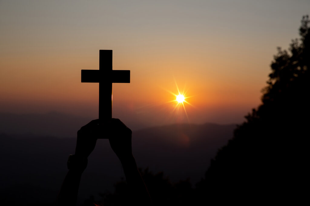 Silhouette of cross at sunrise, symbolizing redemption, hope, and healing in godly marriage