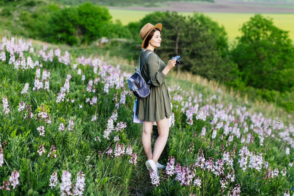 Confident single woman walking peacefully through garden, representing joy and freedom in singleness