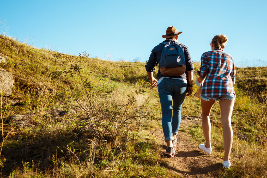Married couple hiking a difficult trail, symbolizing the long-term journey of marriage
