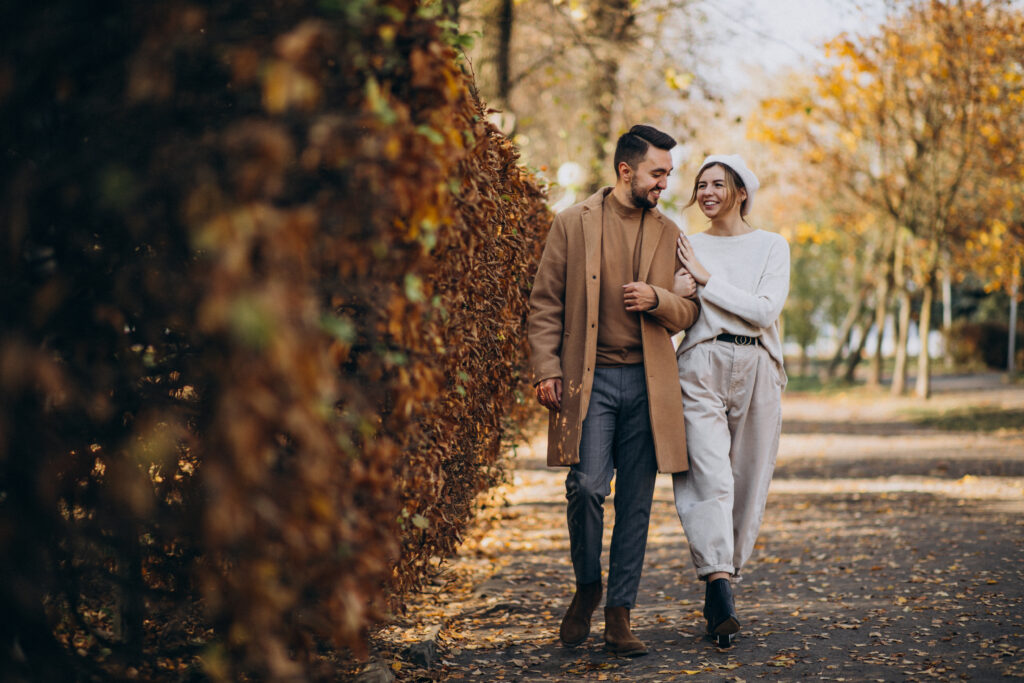 Married couple walking together during autumn, symbolizing seasons of change and enduring connection in marriage