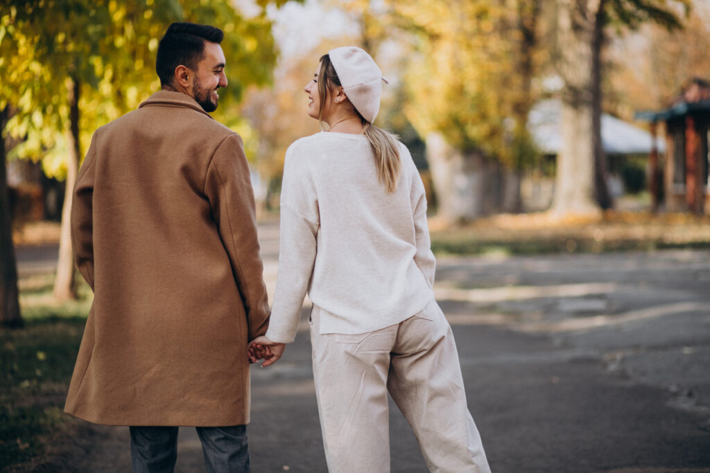 Husband and wife walking hand-in-hand, showing everyday romantic connection