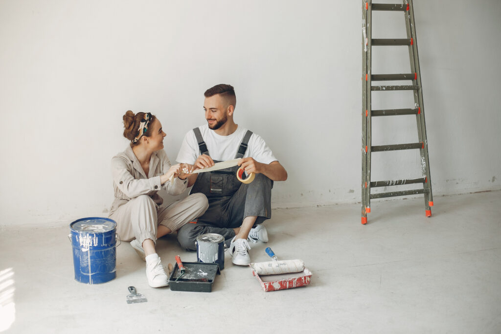 Married couple renovating a room, symbolizing the constructive nature of long-term love and effort