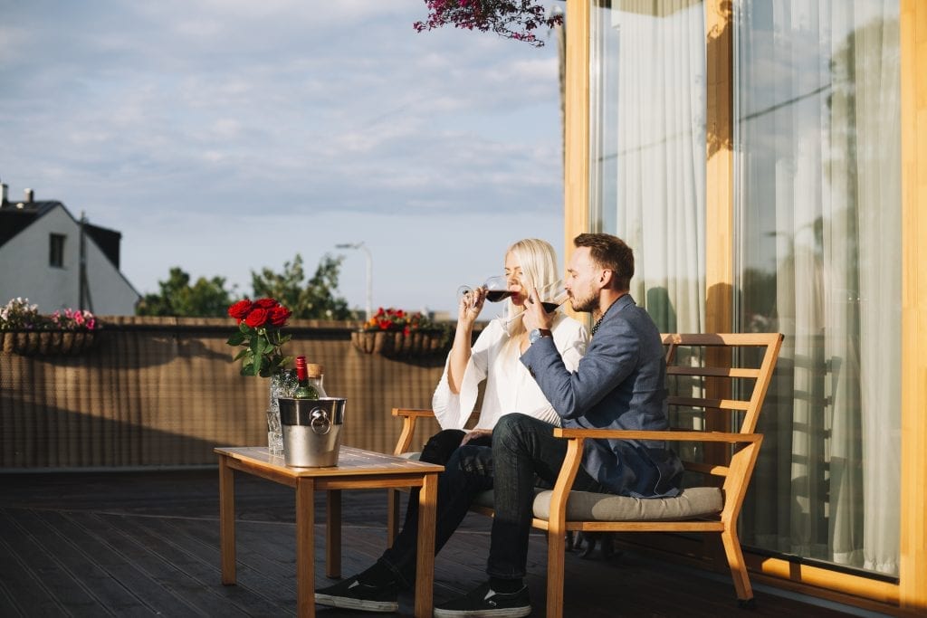 Married couple peacefully sitting together on a porch, symbolizing emotional space