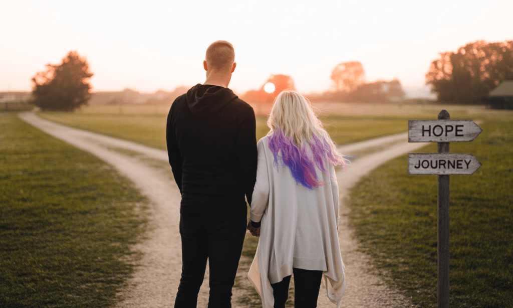 Married couple at a fork in the road symbolizing decisive choices in love and commitment