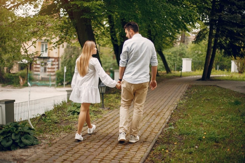 Husband and wife intentionally reconnecting by walking away from unhealthy environmental influences.