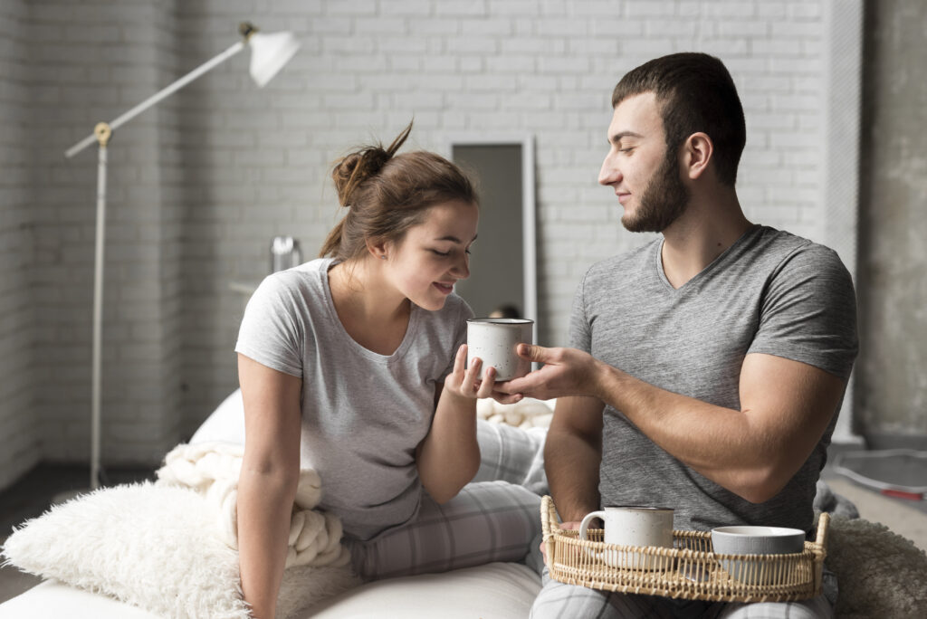 Loving husband bringing coffee to his wife as an act of service.