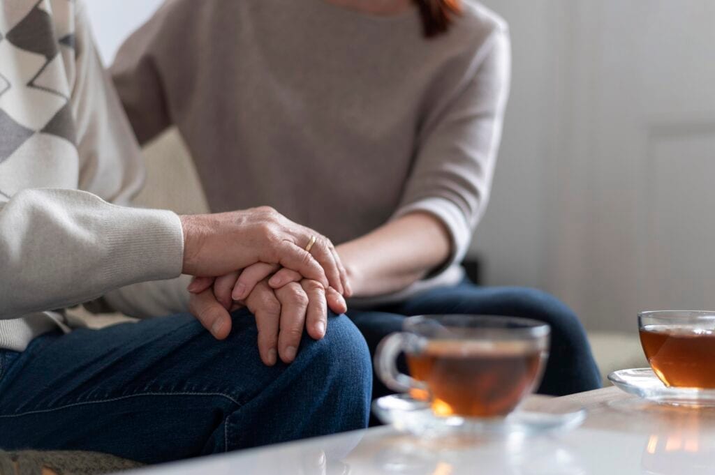 Married couple holding hands and reconnecting, showing grace over grievances
