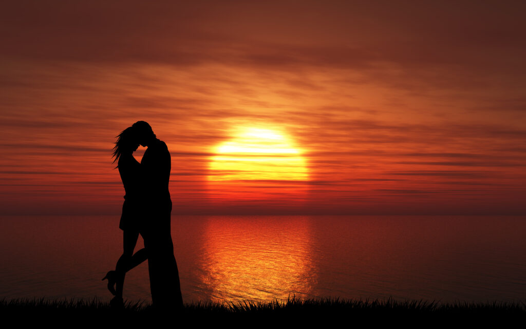 Couple kissing at sunset symbolizing the emotional intensity of infatuation