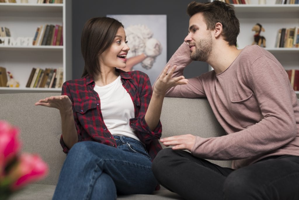 Emotionally safe couple engaged in deep conversation at home