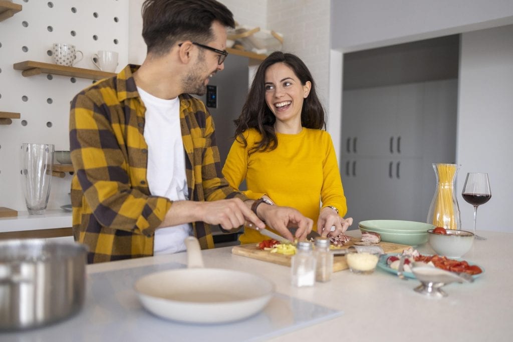 Married couple enjoying quality time together cooking a meal