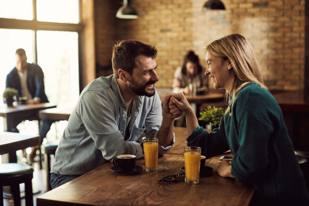 Married couple holding hands and reconnecting during weekly dinner date