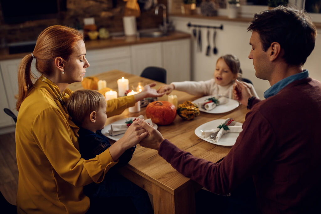 Family sharing a moment of gratitude and faith, anchored in shared values.