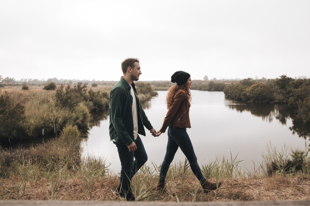 Devoted couple walking outdoors, focused on each other without distractions.