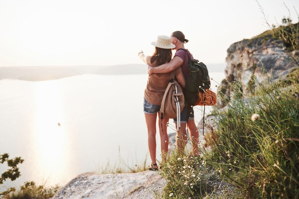 Married couple hiking toward a mountain peak, symbolizing growth and high standards in marriage