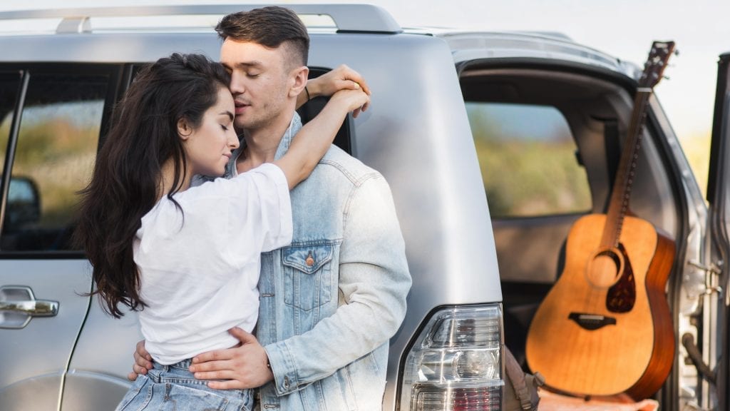 Restored car and happy couple, symbolizing marriage recovery after early warning signs