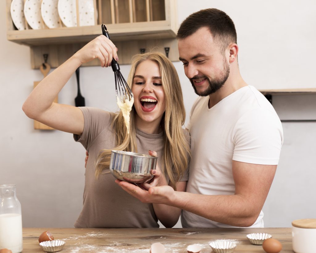 Married couple bonding over a simple date night baking at home