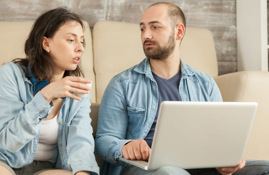 Married couple brainstorming solutions instead of blaming.