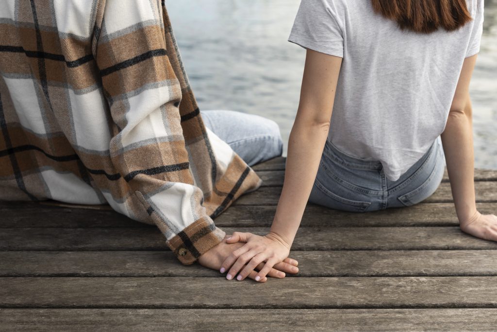 Spouse holding partner’s hand, symbolizing emotional support and love-driven connection