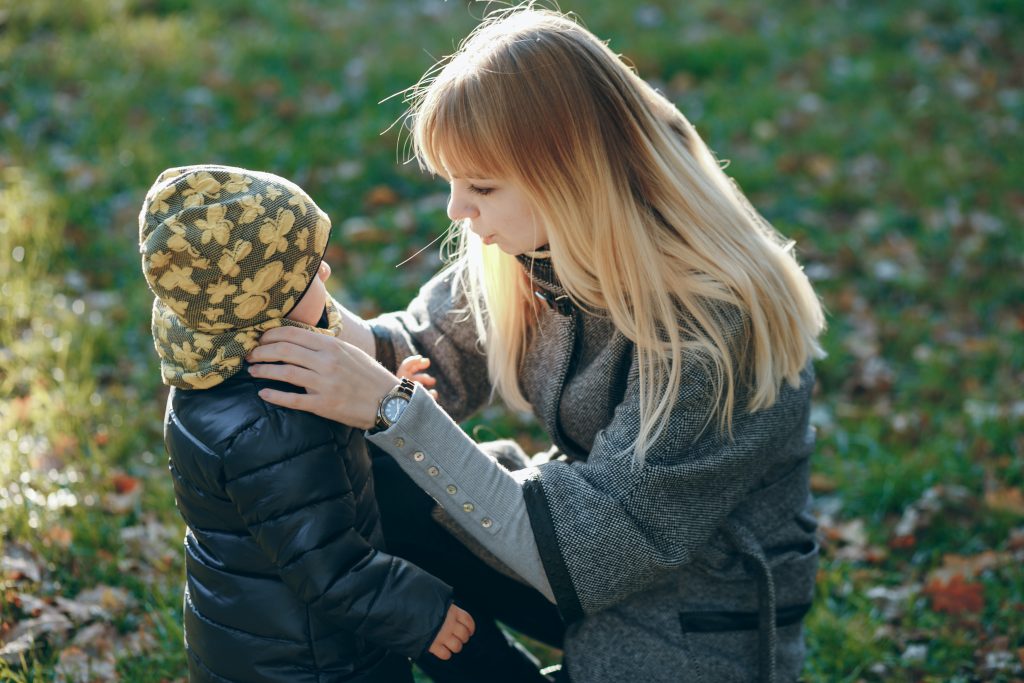Parent comforting child, modeling emotional steadiness that starts in the marriage.