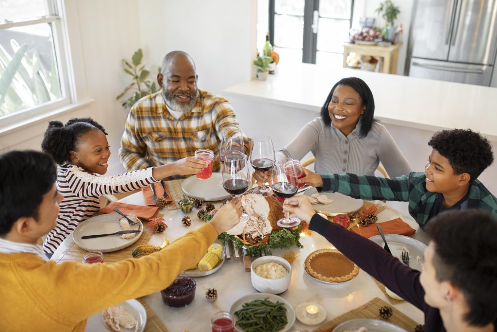 Family laughing around the table, reflecting emotional strength cultivated at home