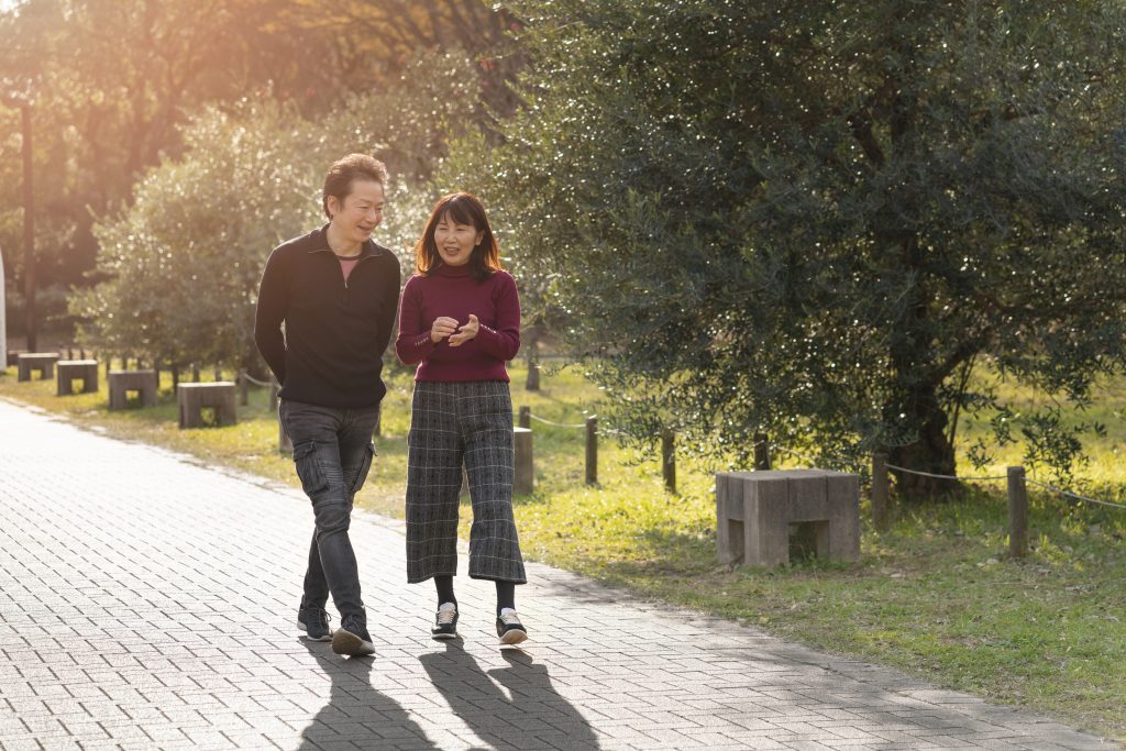 Healthy married couple walking and talking, investing in emotional connection