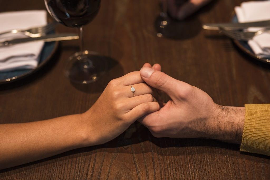 Married couple sharing gratitude during dinner to strengthen connection and avoid arguments.