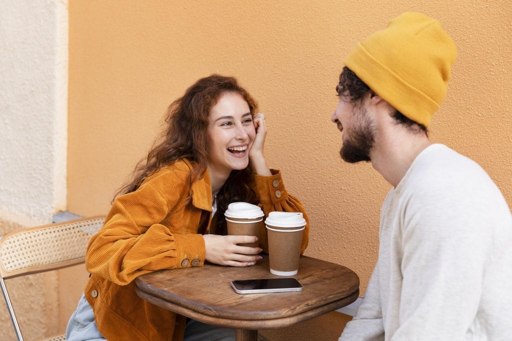 Married couple sharing focused conversation over coffee without digital distractions