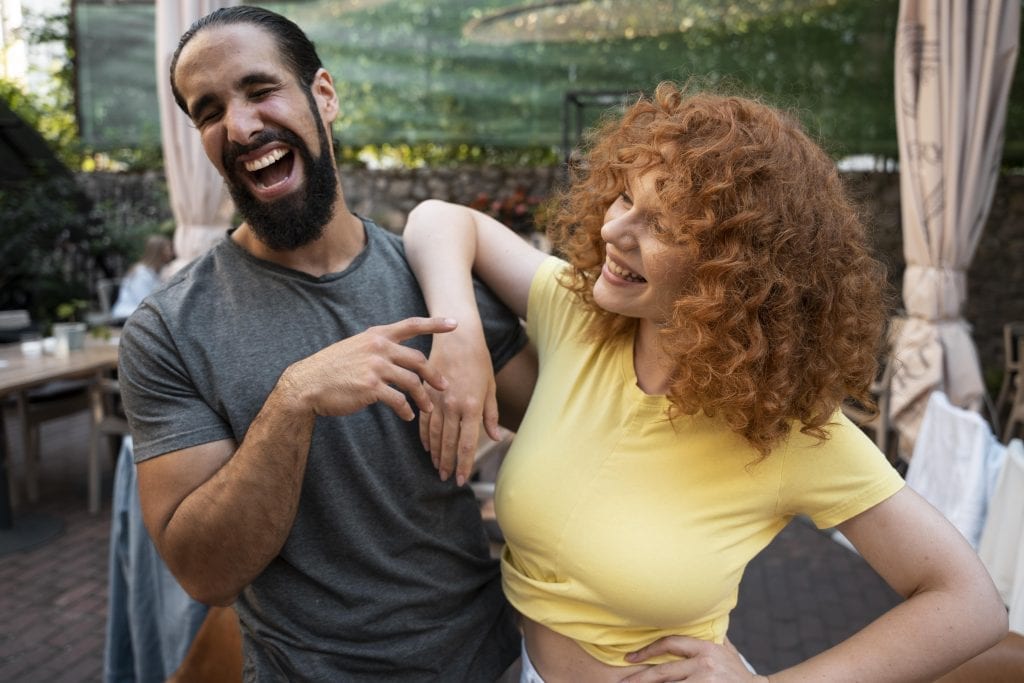 Married couple smiling and speaking kindly to each other.