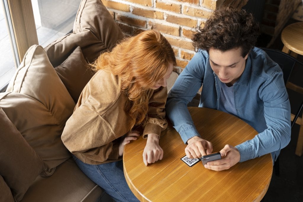 One spouse engaged on their phone while the other feels unseen, symbolizing emotional disconnection reinforced by attention.