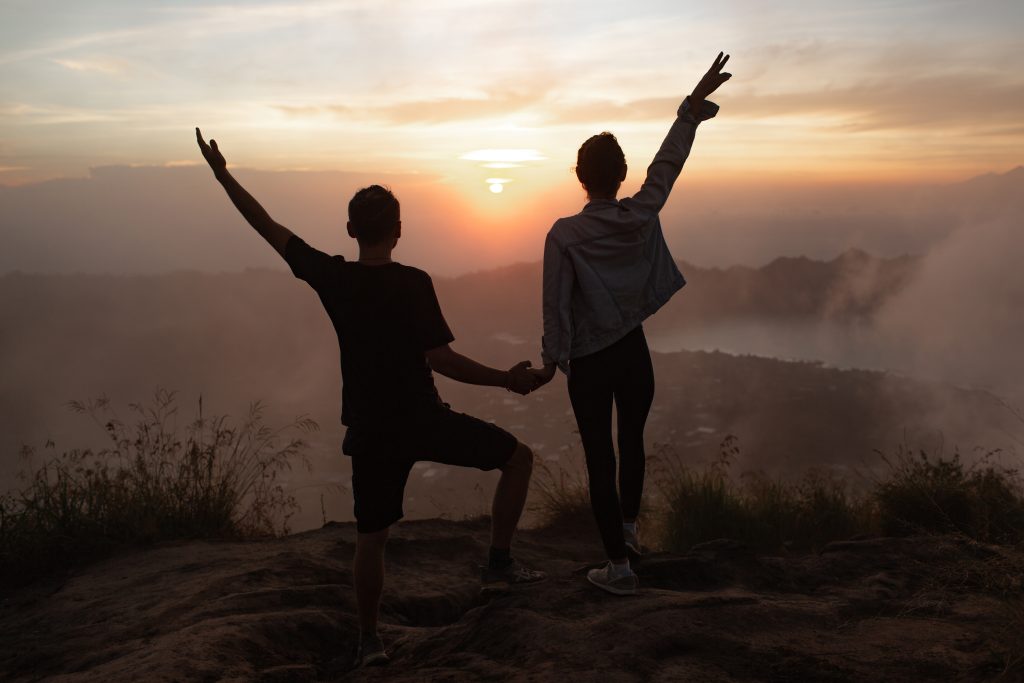 Couple facing sunrise together, symbolizing new beginnings and hopeful commitment